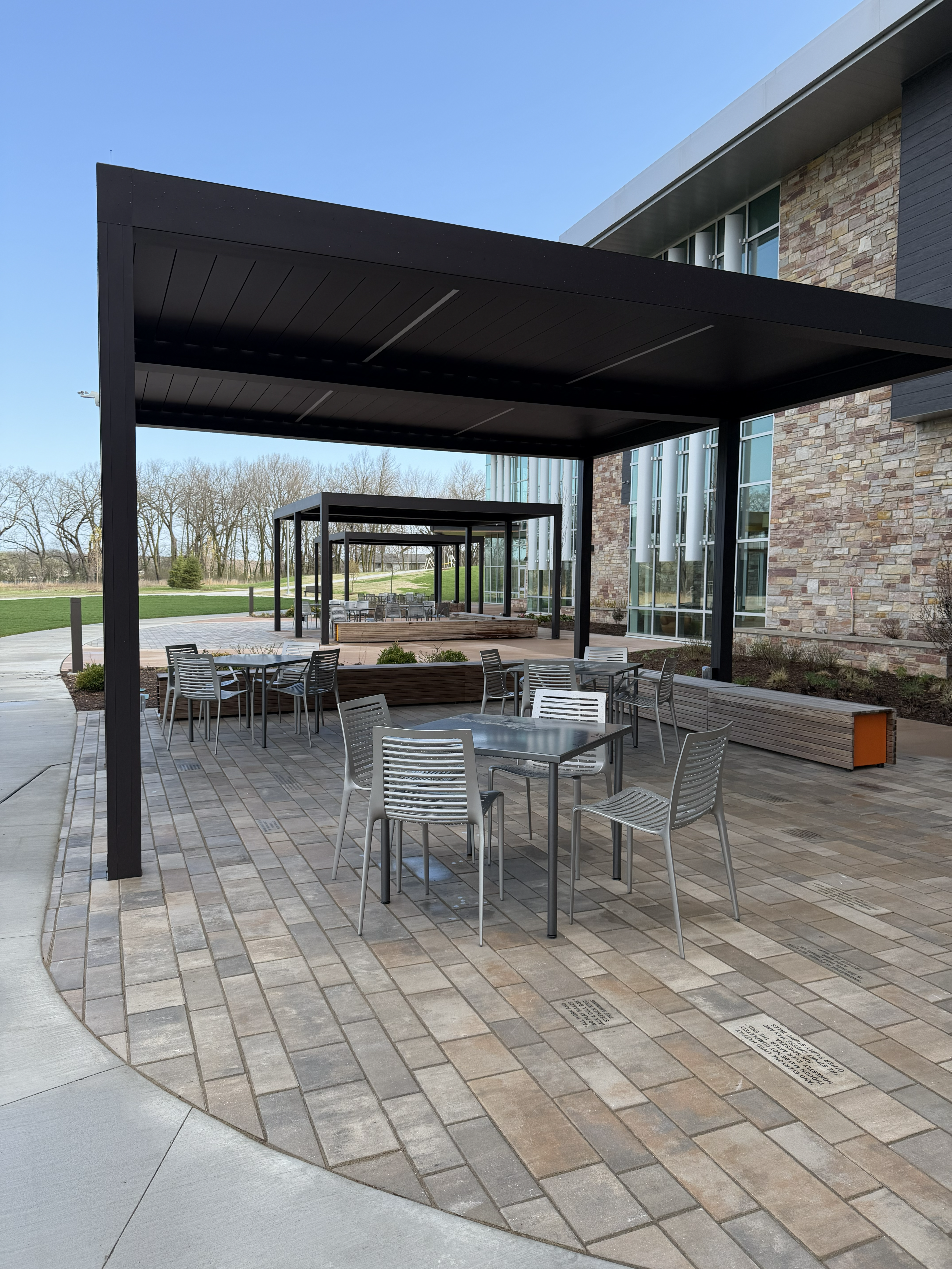 New Shade structures and tables with chairs on the patio