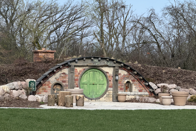 A photograph of a decorative hobbit house inspired berm at the library